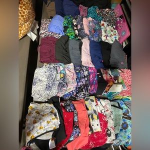 31 scrub tops, 10 pairs of scrub pants and 3 scrub jackets all different bands.